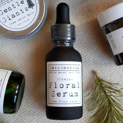 Glowing Floral Serum bottle with botanical materials and other Deschampsia products