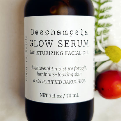 Close-up of the Deschampsia Glow Serum 30 mL label showing moisturizing facial oil and 0.5% purified bakuchiol.